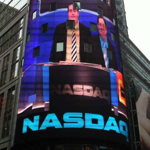 Kevin and Brett Young on the giant screen of the Nasdaq building in Times Square, New York City, while ringing the closing bell